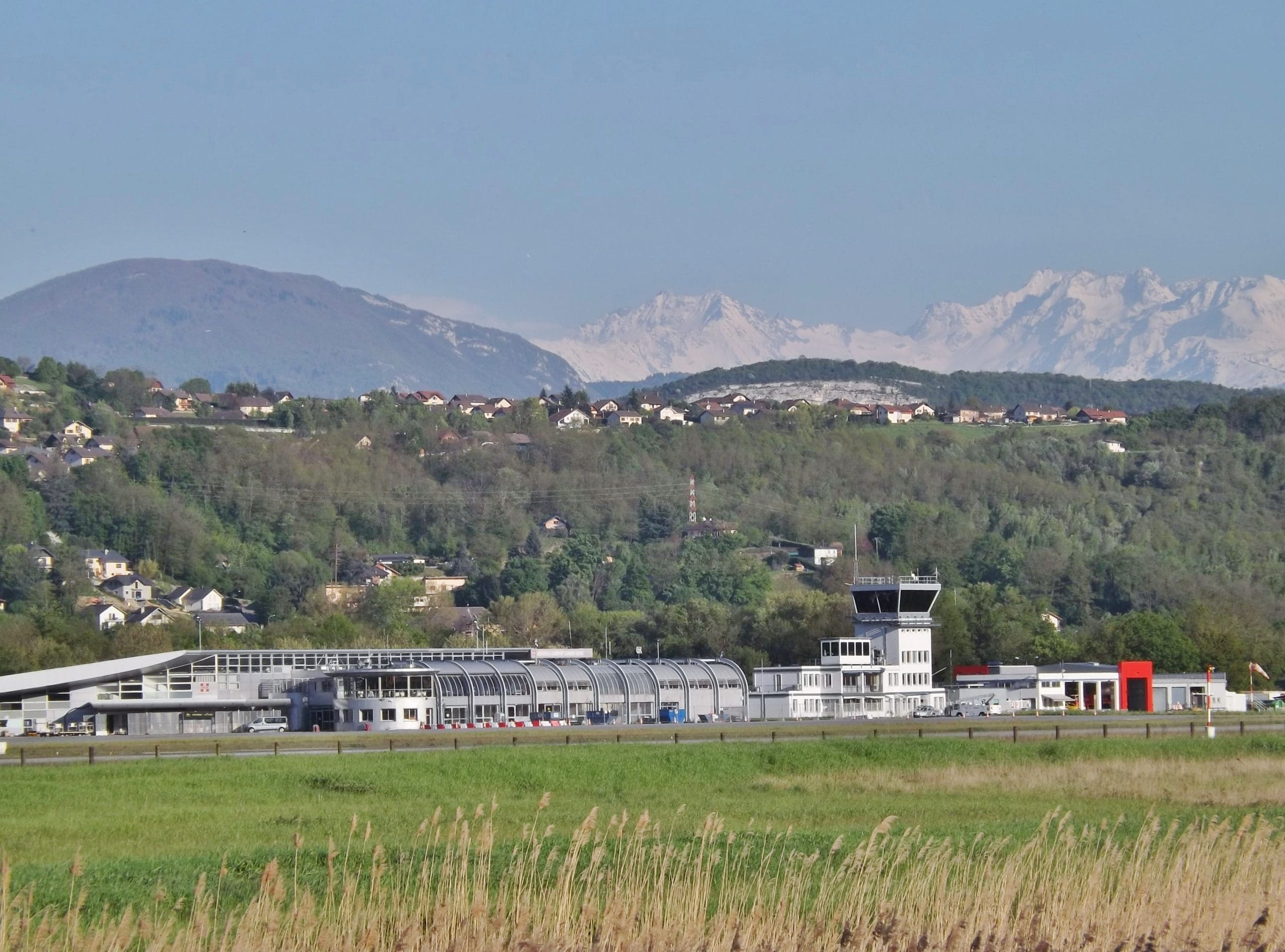 Chambéry Airport terminal and control tower with mountains in the background