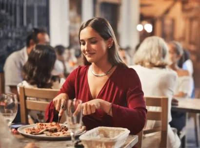 A woman eats dinner in an Alpine restaurant