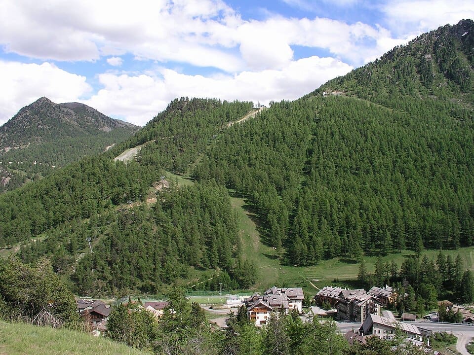 General view of the snow-covered slopes and village of Claviere