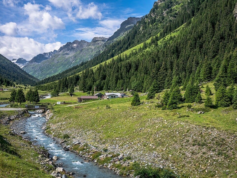 Mentaalm hut in the Jamtal Valley near Galtür with the Silvretta mountains in the background