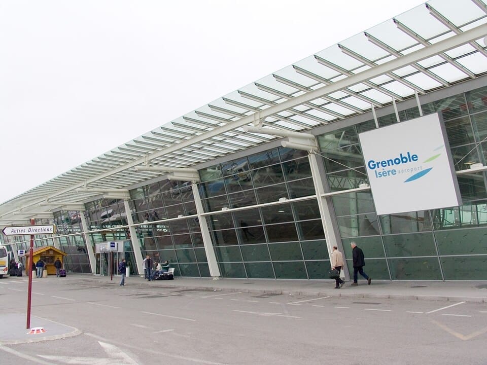 Exterior view of the Grenoble Alpes Isère Airport terminal building.