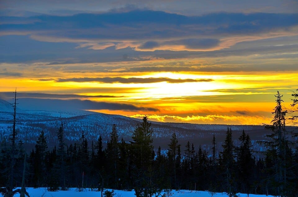 A cold sunset over the snowy peaks and village of Lofsdalen, Sweden