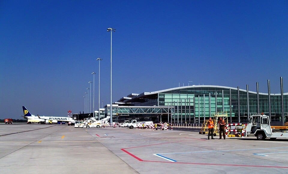 Exterior view of the modern glass terminal building at Nicolaus Copernicus Wrocław Airport.